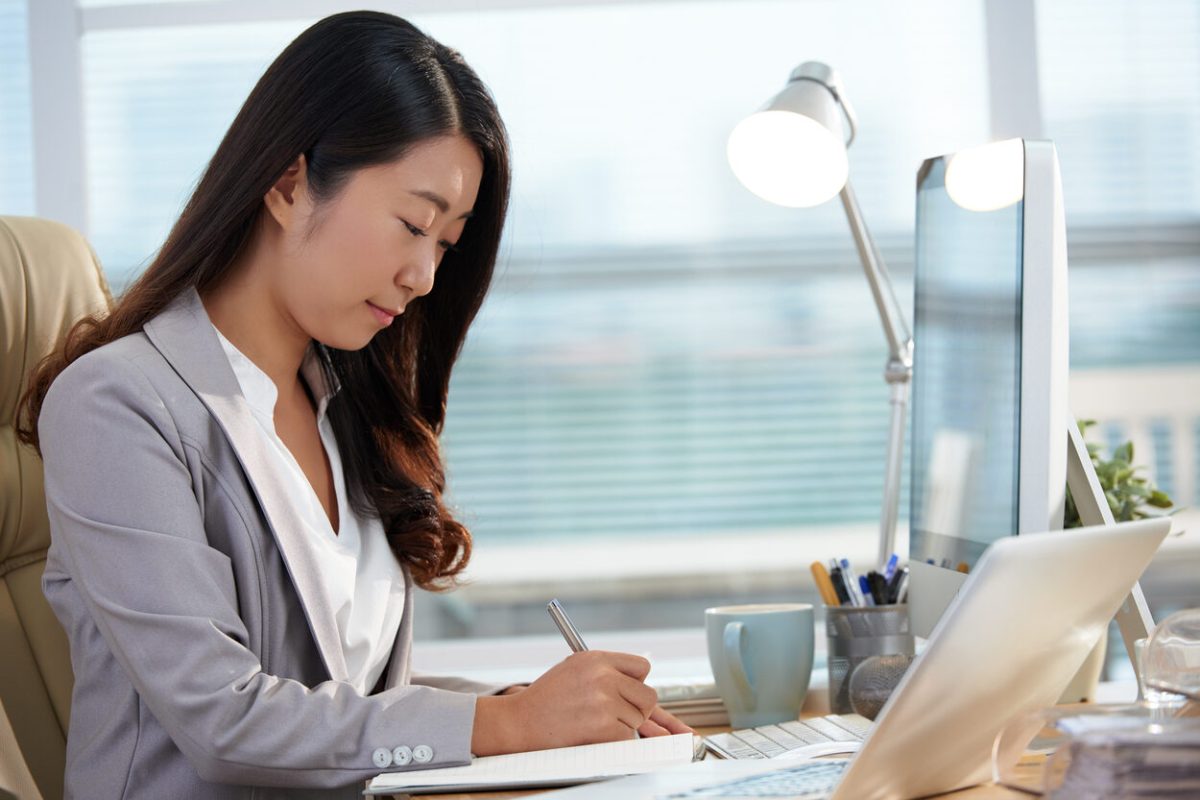 Portrait of young financial manager working with papers