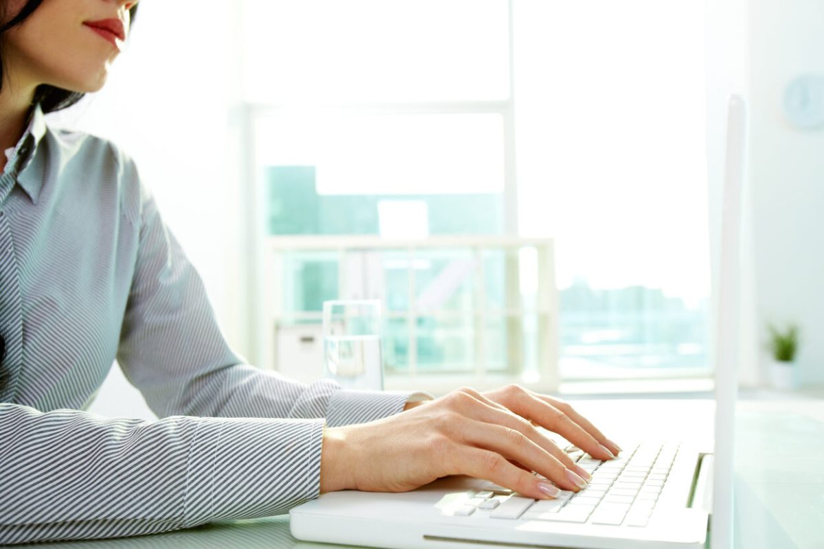 Business lady typing on laptop at office