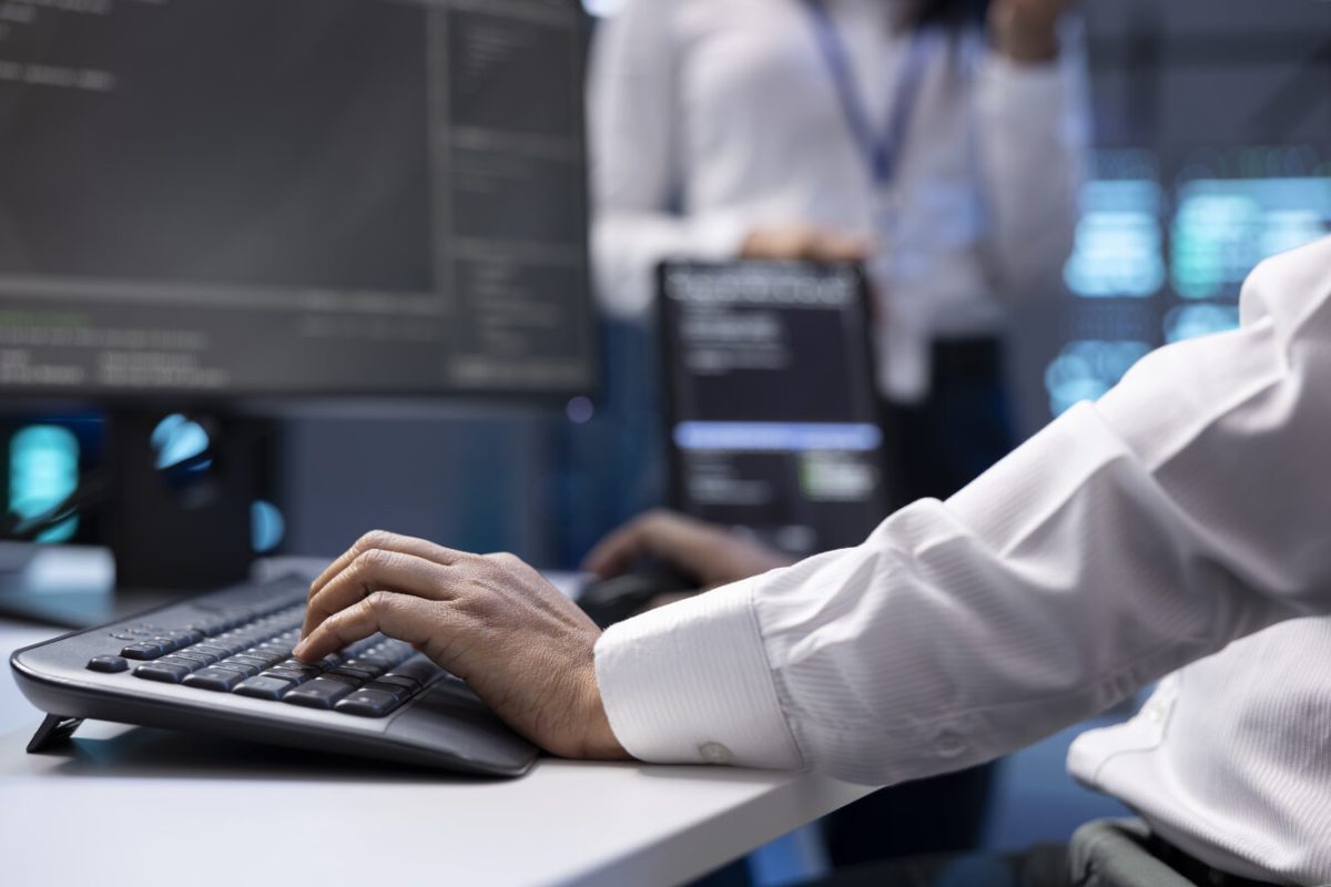 IT specialist ensuring server farm systems provide redundancy, automatic failover and rapid reconfiguration of clusters to minimize failure of individual machines, close up shot