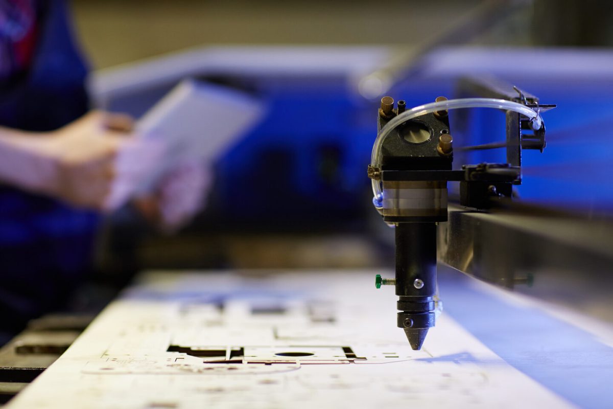 Laser cutting beam over plywood sheet