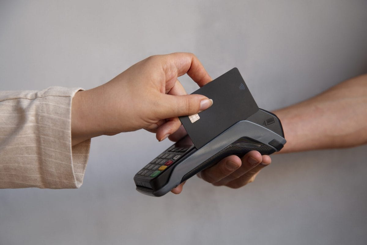 side-view-customer-paying-with-nfc-device (1)