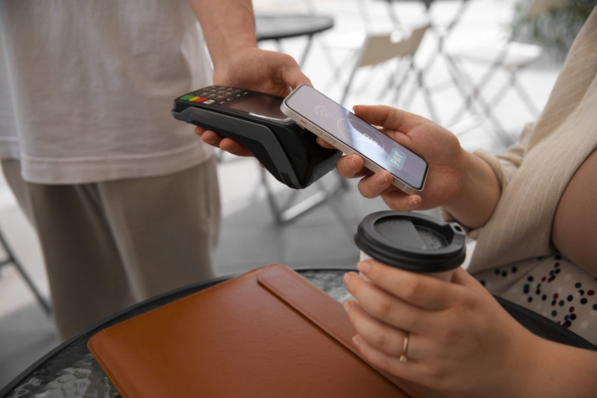 side-view-customer-paying-with-nfc-device (1)
