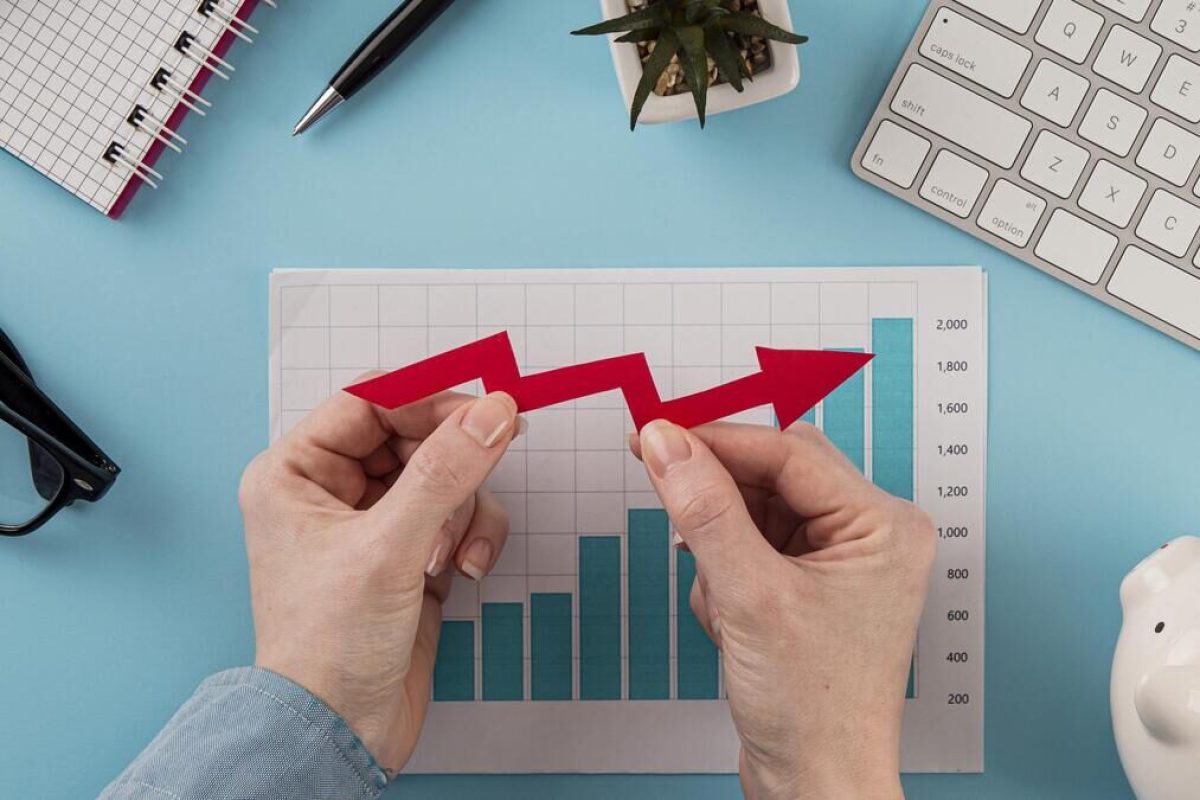 top-view-business-items-with-growth-chart-hands-holding-arrow (1)