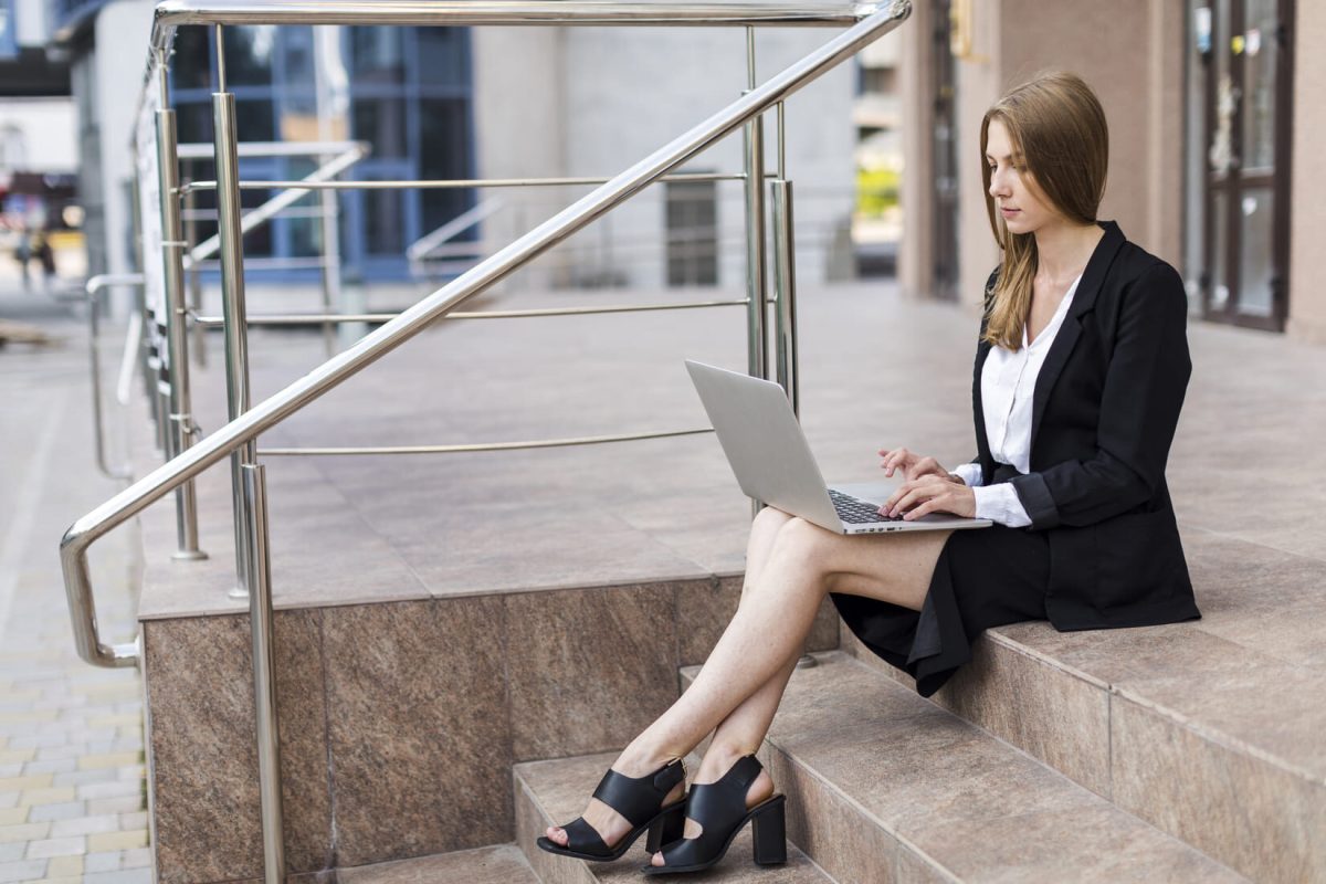 woman-sitting-stairs-using-her-laptop (1) (1)