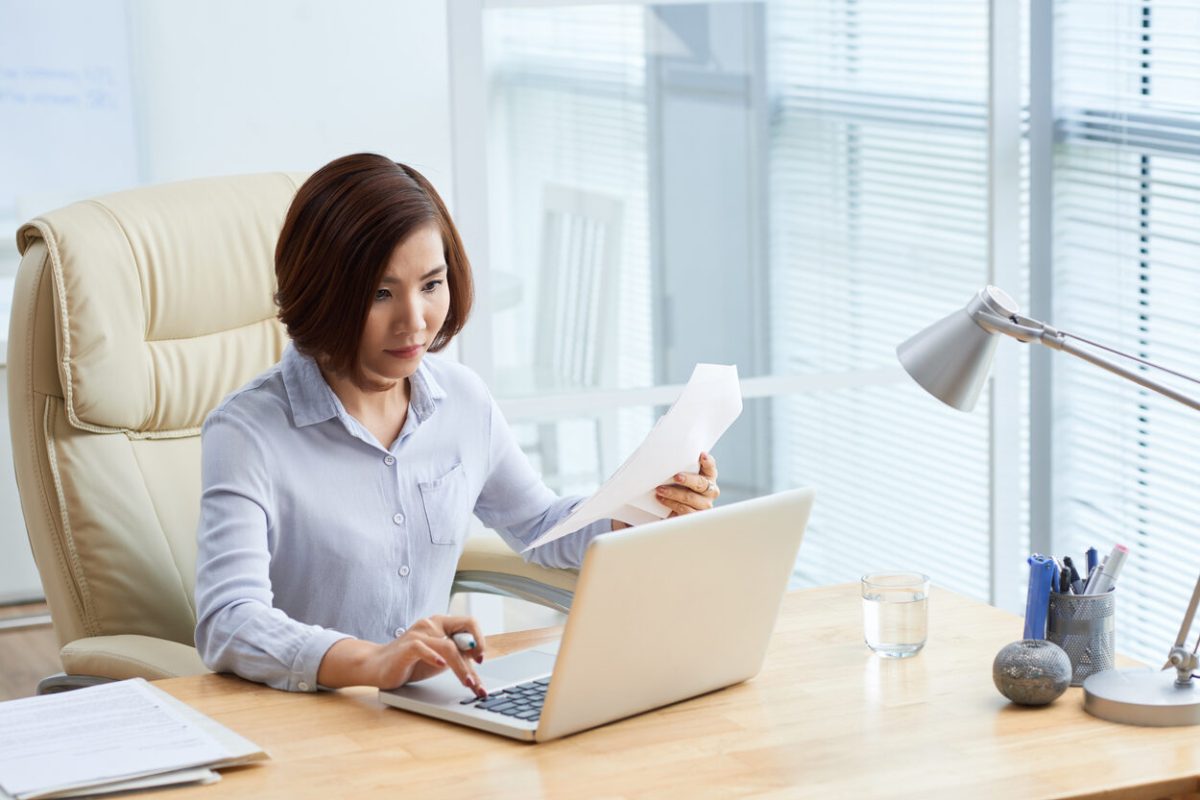 Asian young business woman working on laptop in office
